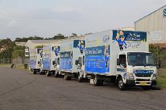 4 Plumbing Trucks Lined Up
